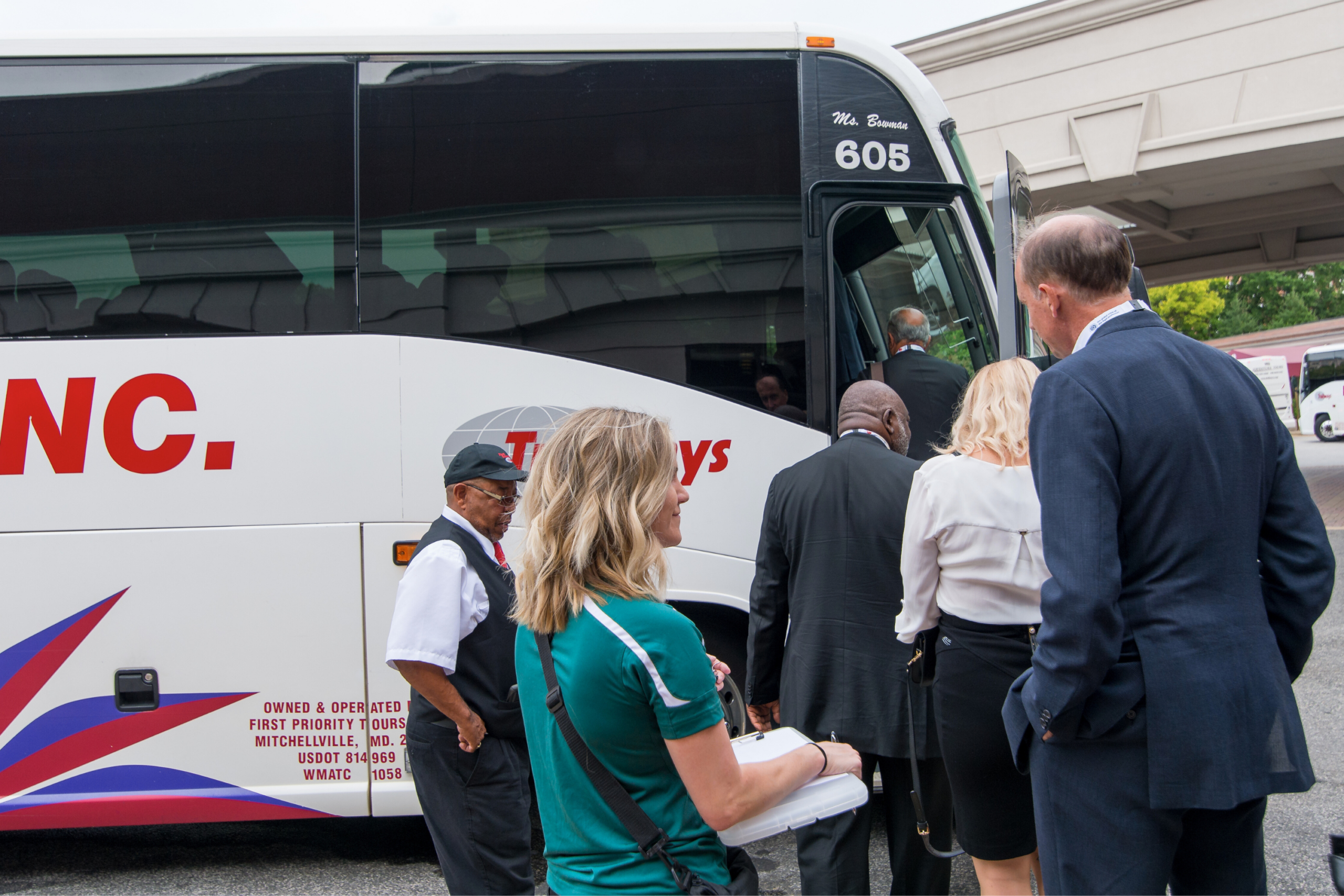 People lined up getting on a bus