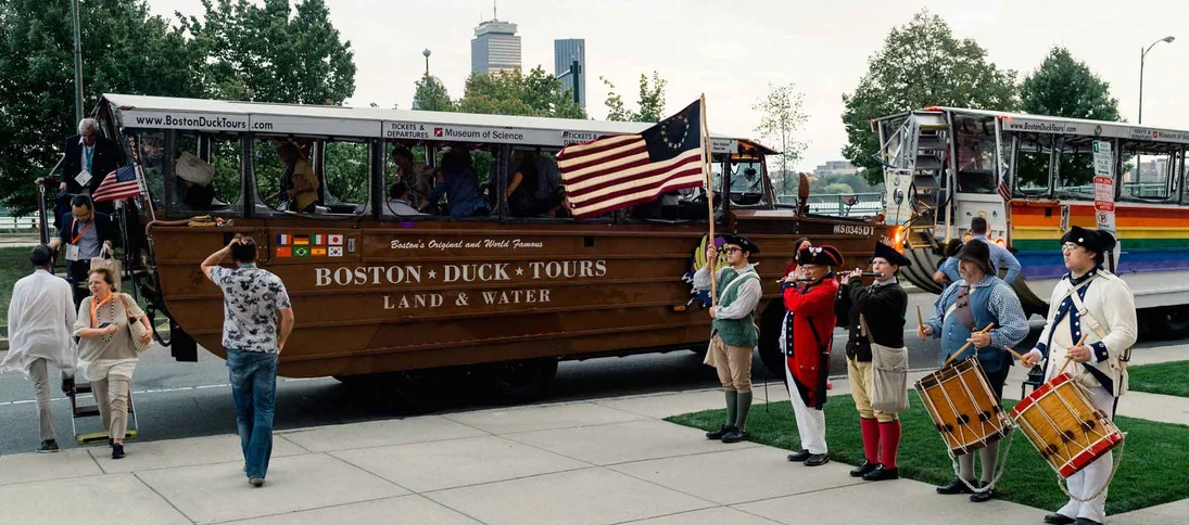 Boston rein actors next to a clAsIc duck tour